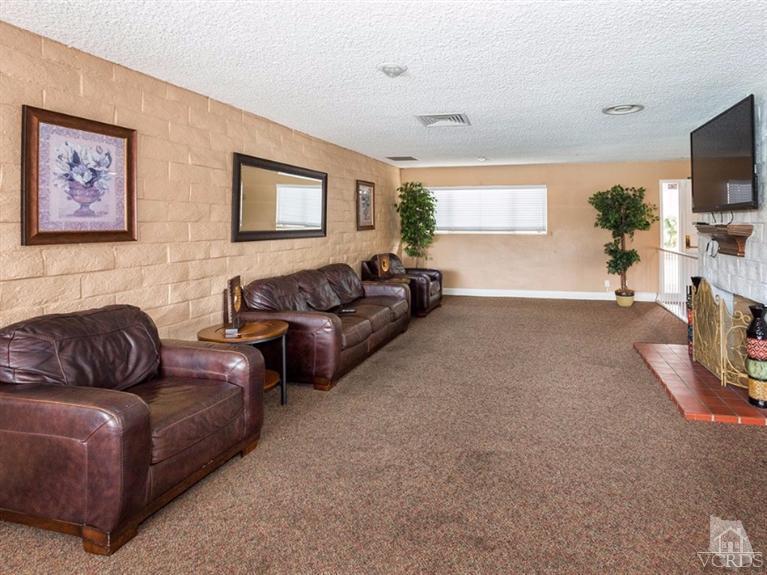 2400 East Pleasant Valley Road, Unit 136 Oxnard, CA 93033 - Photo 16 of 16 a living room with furniture and a flat screen tv