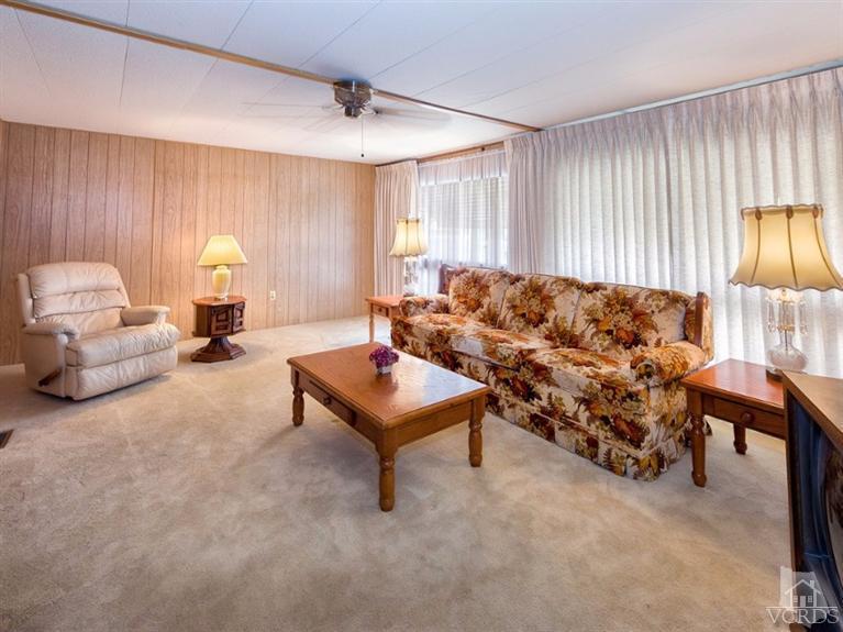 2400 East Pleasant Valley Road, Unit 136 Oxnard, CA 93033 - Photo 4 of 16 a living room with furniture and a lamp