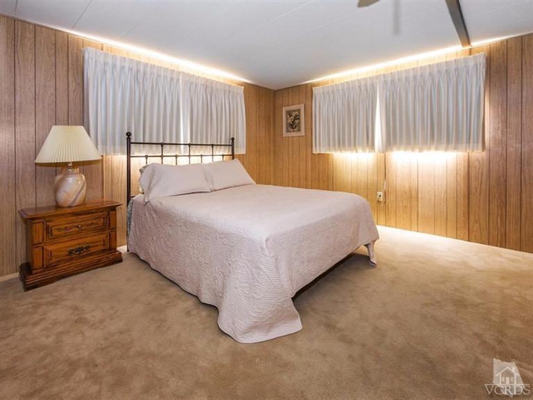 2400 East Pleasant Valley Road, Unit 136 Oxnard, CA 93033 - Photo 6 of 16 a bedroom with a bed and a lamp