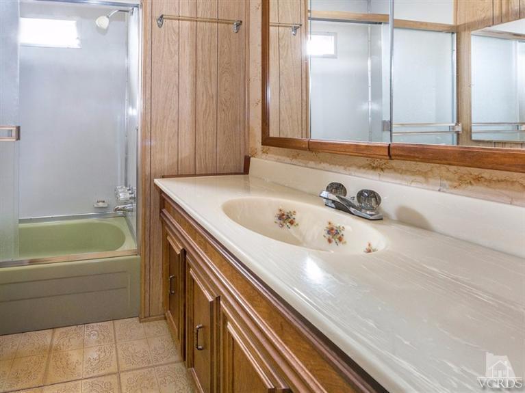 2400 East Pleasant Valley Road, Unit 136 Oxnard, CA 93033 - Photo 7 of 16 a bathroom with a tub sink and mirror