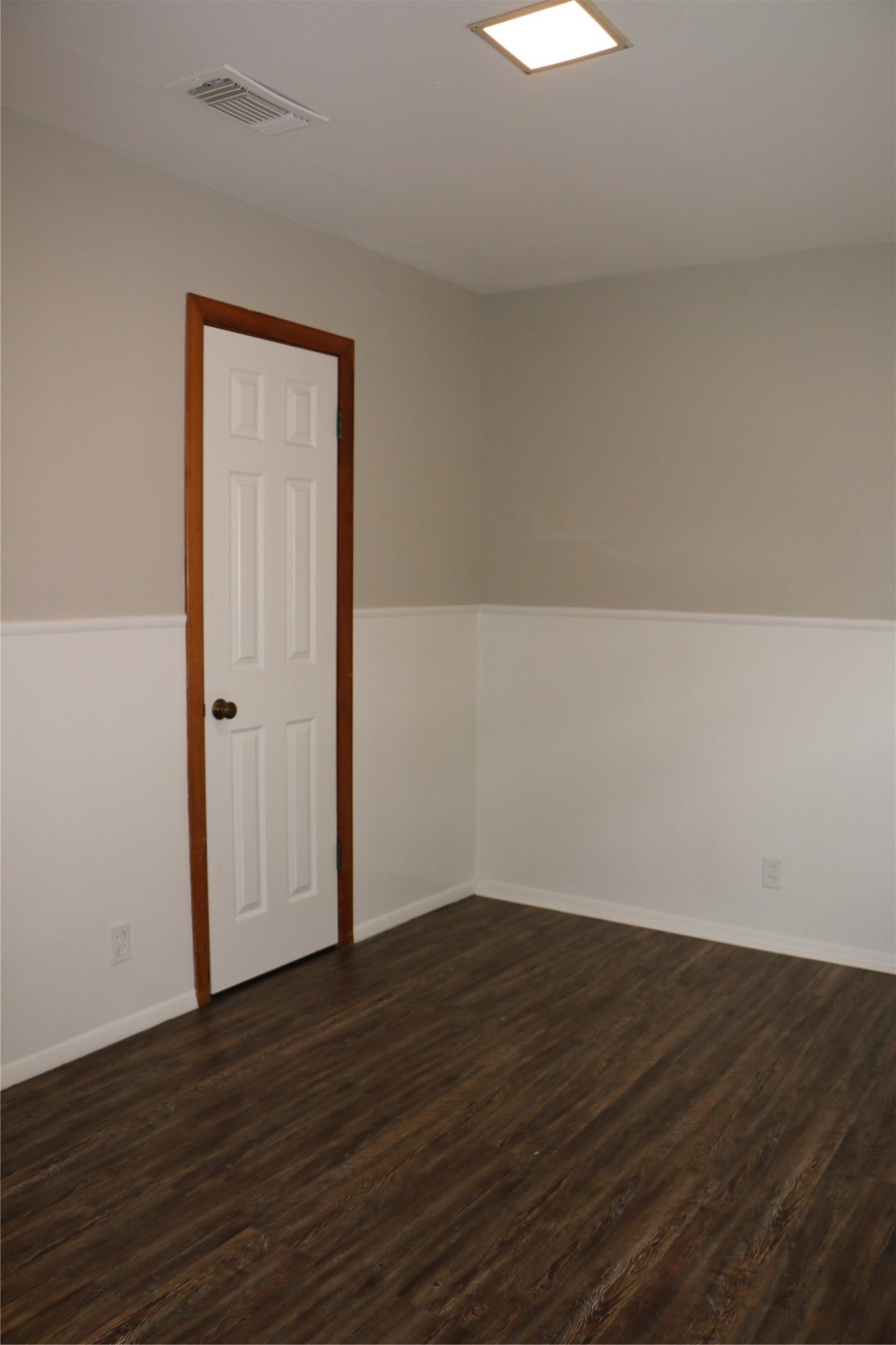 710 West 7th Street Freeport, TX 77541 - Photo 12 of 20 an empty room with wooden floor and windows