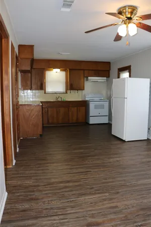 a view of room with cabinets and wooden floor