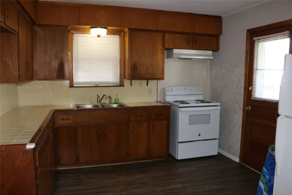 a utility room with cabinets washer and dryer