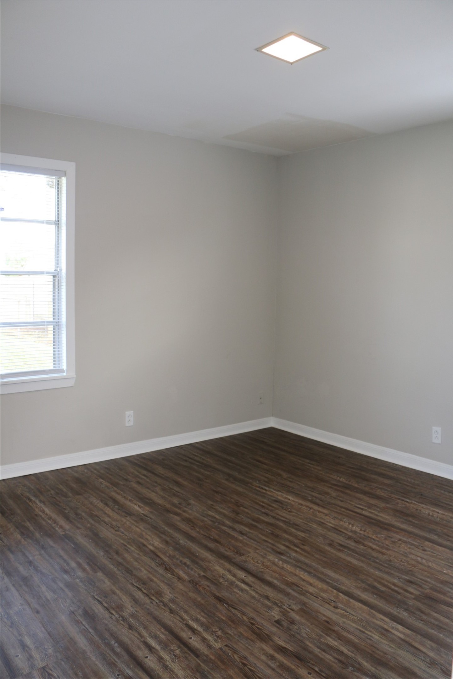 710 West 7th Street Freeport, TX 77541 - Photo 5 of 20 a view of an empty room with wooden floor and a window