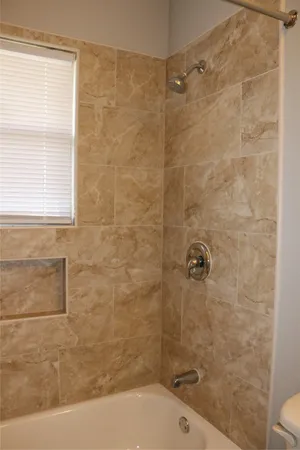 a bathroom with a shower and a toilet sink