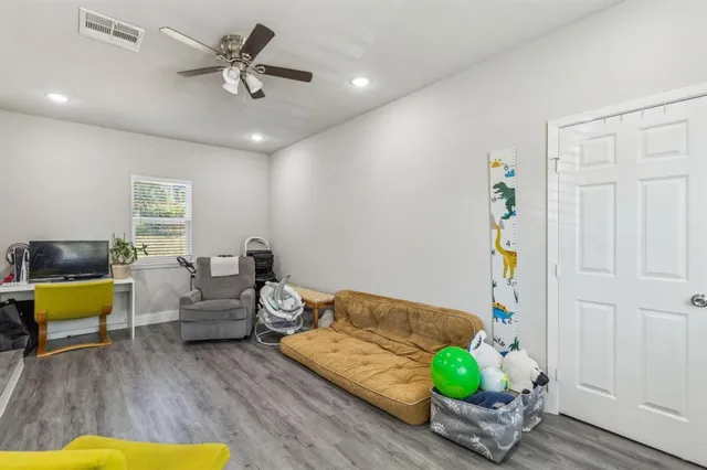 a view of a livingroom with furniture and a flat screen tv