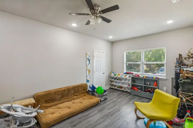 a living room with furniture and wooden floor