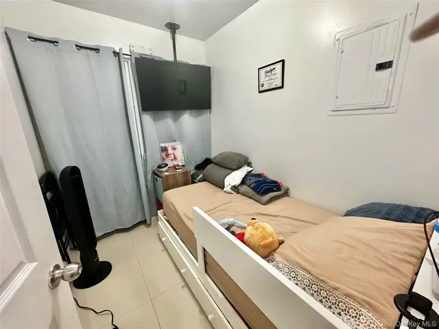 a bedroom with a bed and a mirror