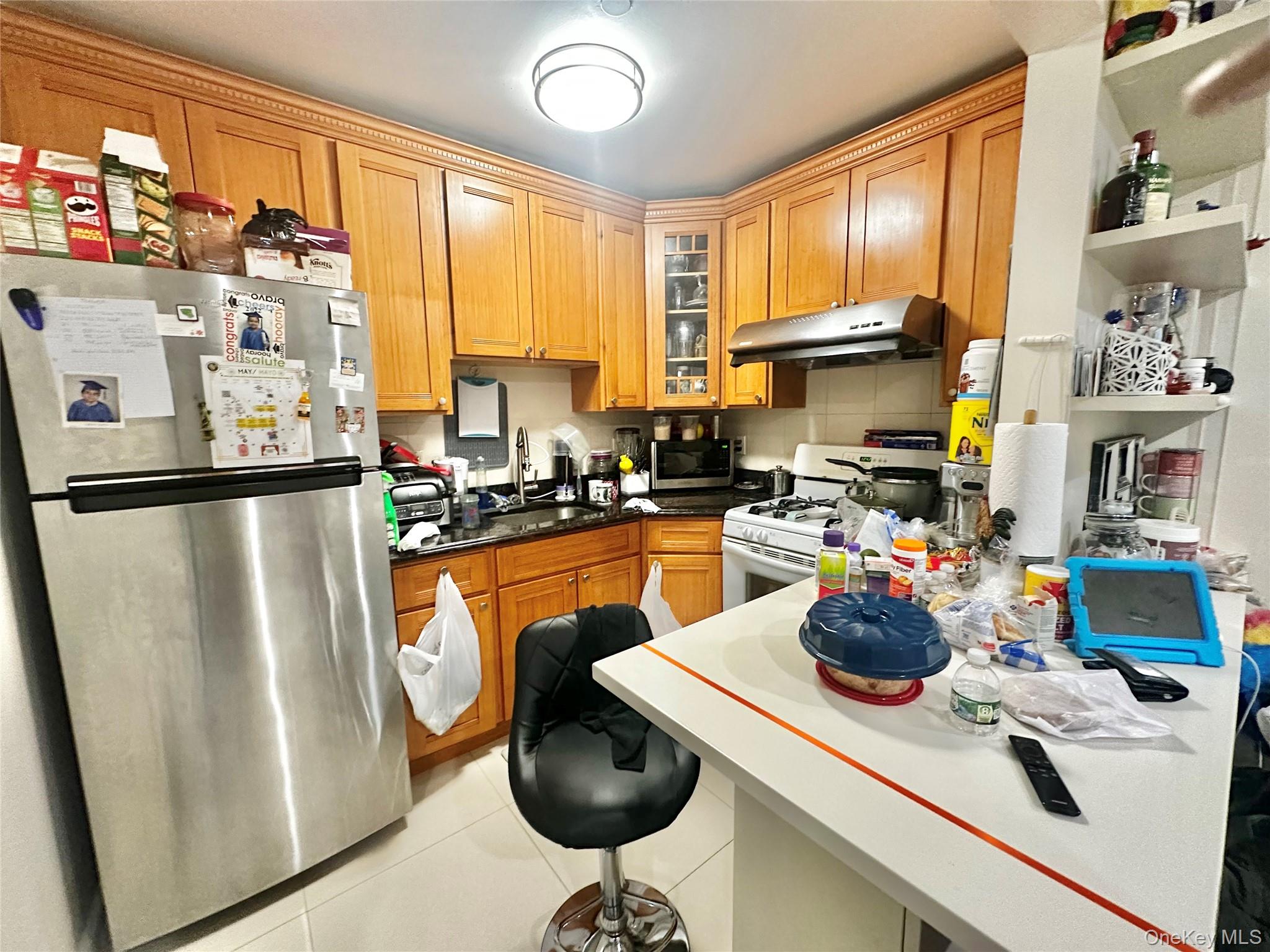 104-48 37th Drive, Unit 3A Queens, NY 11368 - Photo 5 of 17 a kitchen with stainless steel appliances a refrigerator a sink a stove and a cabinets