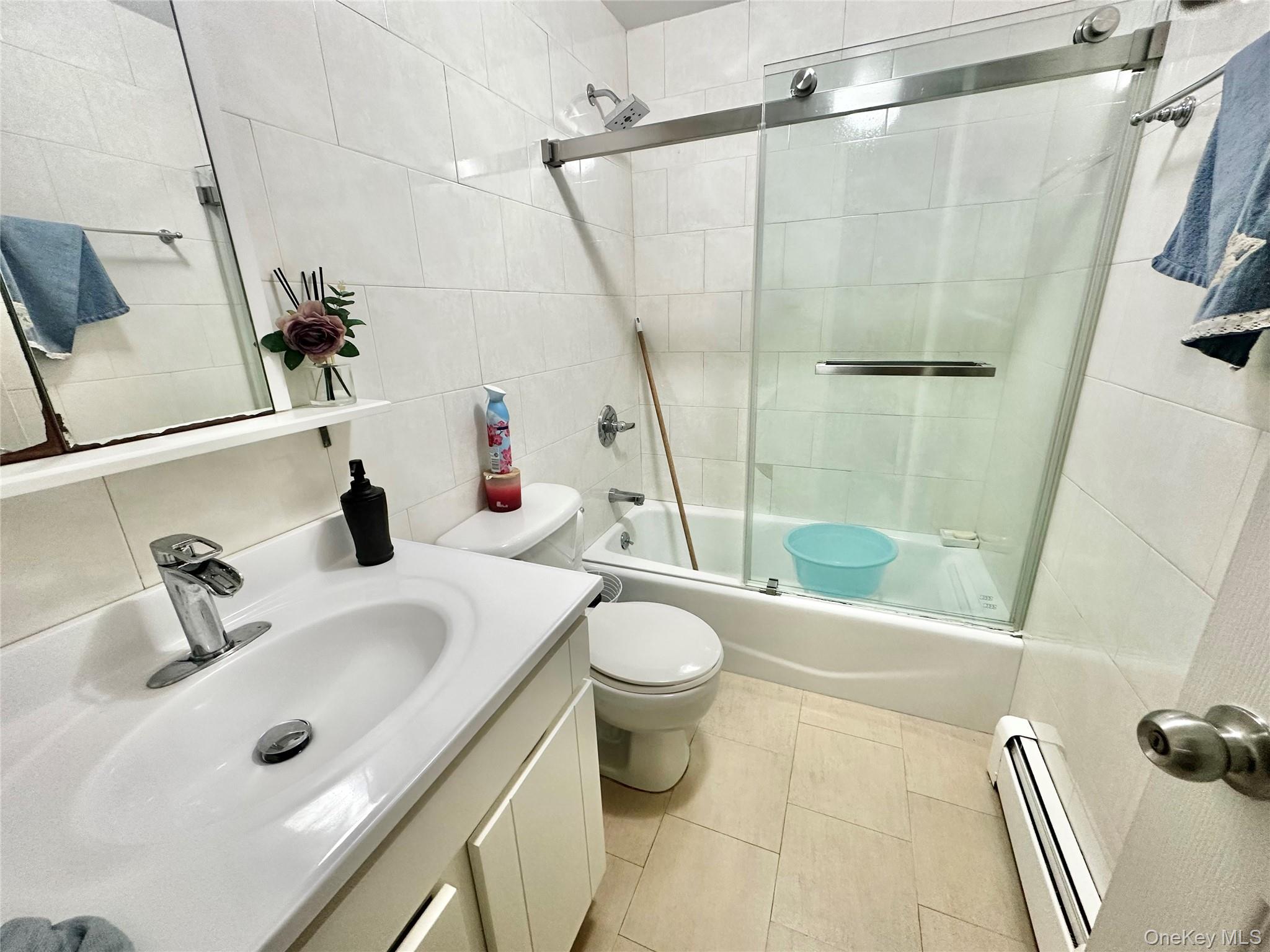 104-48 37th Drive, Unit 3A Queens, NY 11368 - Photo 8 of 17 a bathroom with a sink toilet and shower