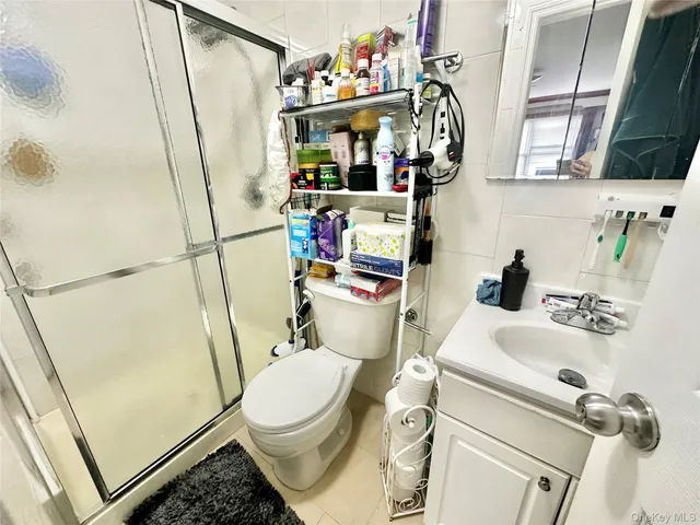 a bathroom with a sink a toilet and shower curtain