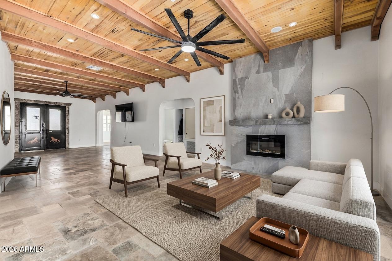 317 West Frontier Street Apache Junction, AZ 85120 - Photo 2 of 14 a living room with furniture a fireplace and a table
