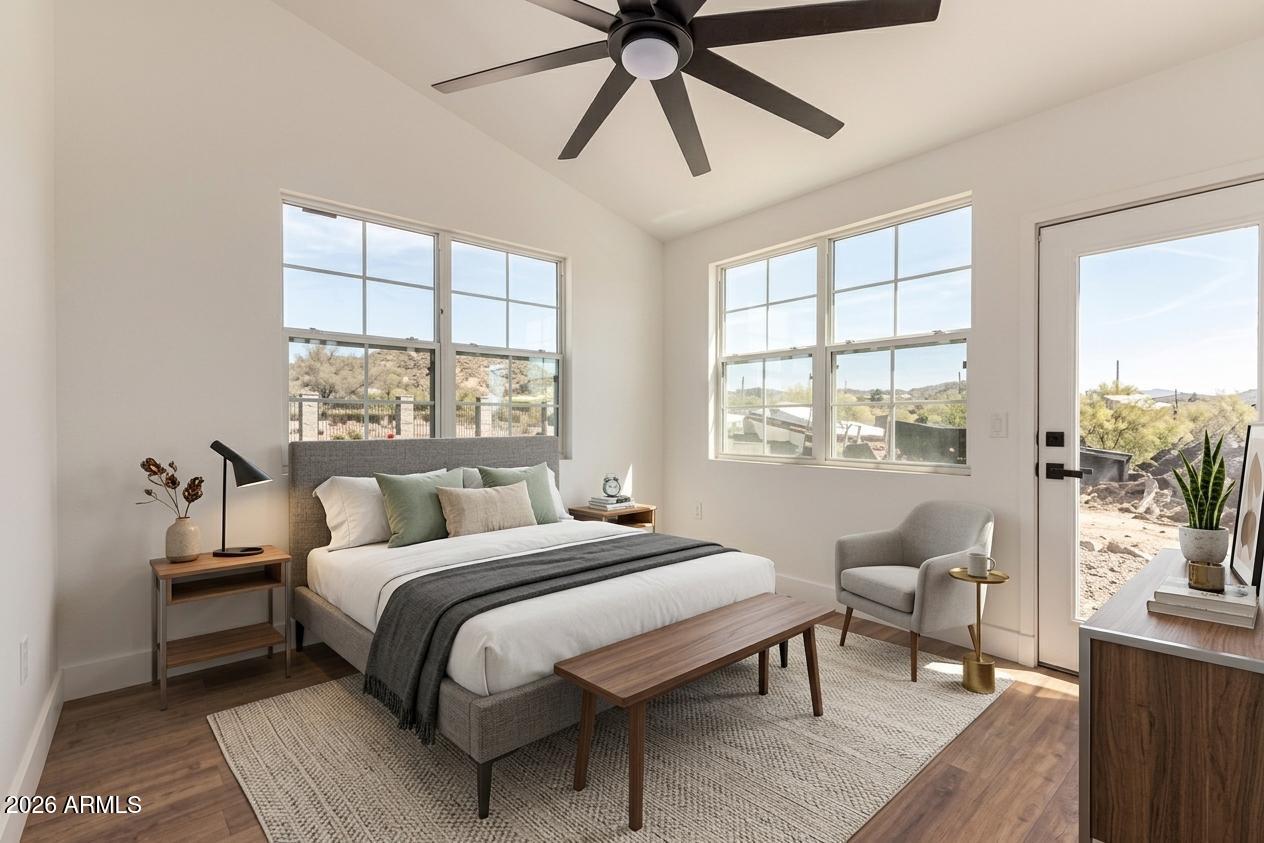 317 West Frontier Street Apache Junction, AZ 85120 - Photo 8 of 14 a bedroom with a bed and a chandelier