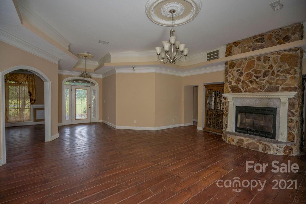 577 Crousetown Road Lexington, NC 27292 - Photo 3 of 39 a view of livingroom with fireplace wooden floor and chandelier