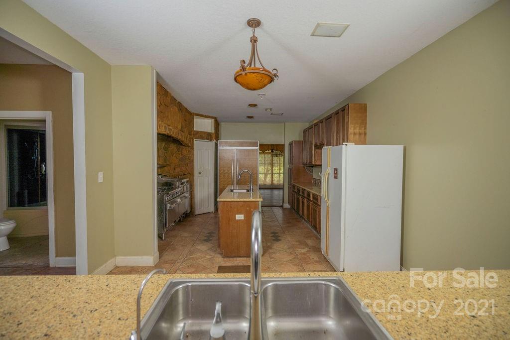 577 Crousetown Road Lexington, NC 27292 - Photo 10 of 39 a kitchen with refrigerator and window