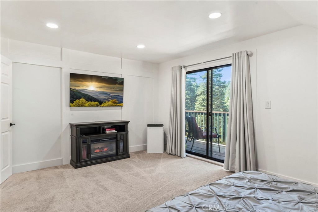 899 Blue Ridge Drive Lake Arrowhead, CA 92385 - Photo 30 of 49 a view of livingroom with furniture flat screen tv and floor to ceiling window