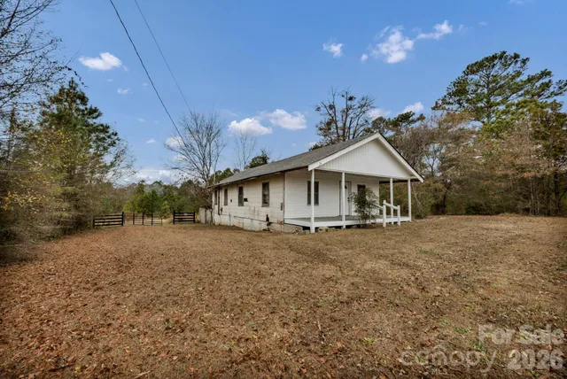 a view of a patio with table and chairs potted plants with wooden fence