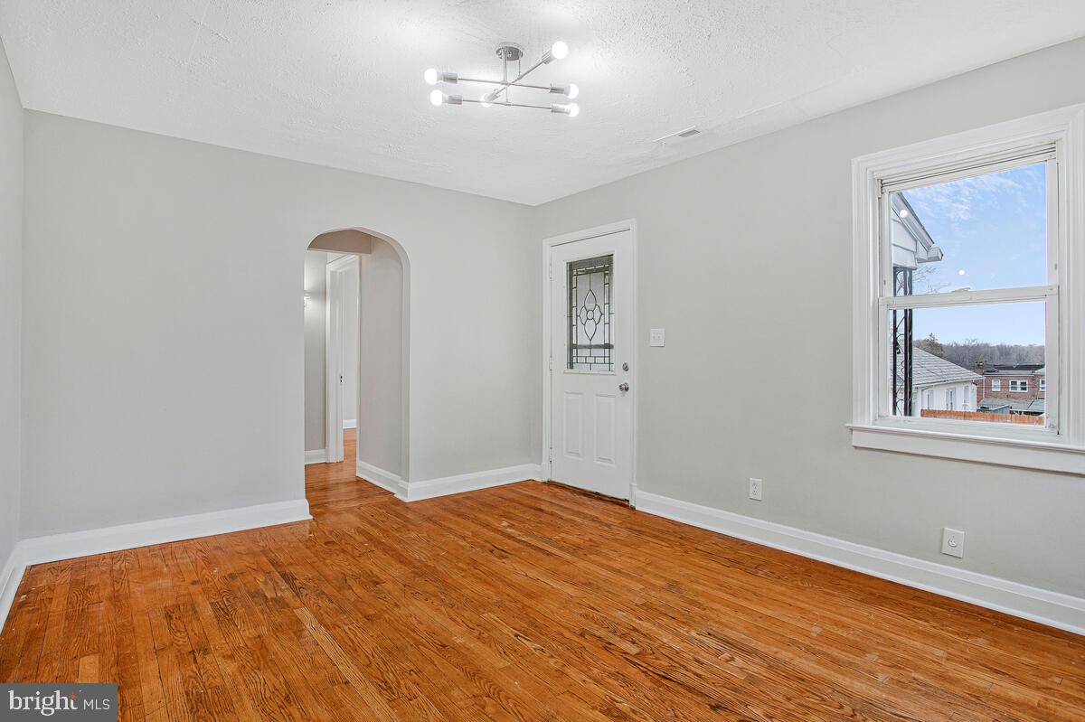 119 West Edgevale Road Baltimore, MD 21225 - Photo 12 of 37 a bedroom with a bed and a painting on the wall
