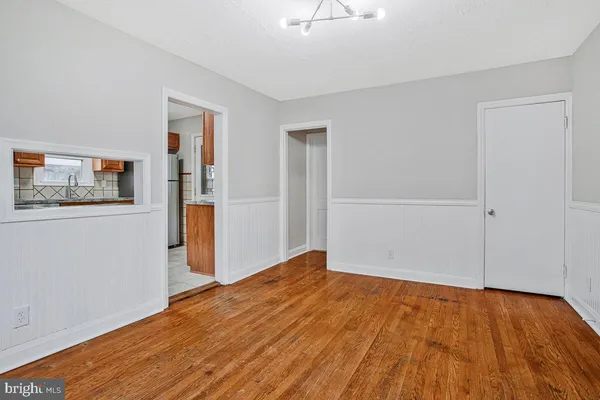 a view of empty room with wooden floor