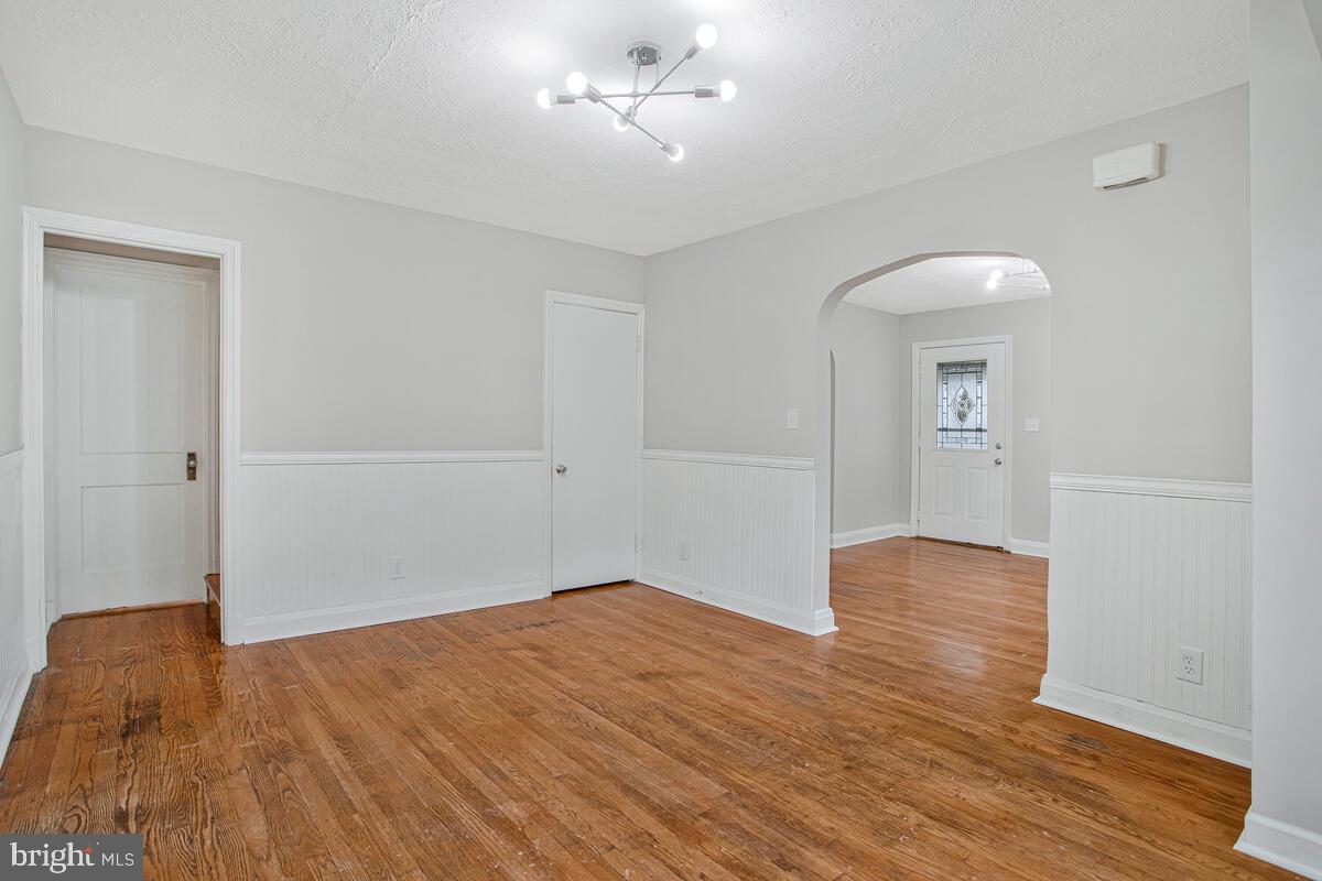 119 West Edgevale Road Baltimore, MD 21225 - Photo 15 of 37 an empty room with wooden floor and windows