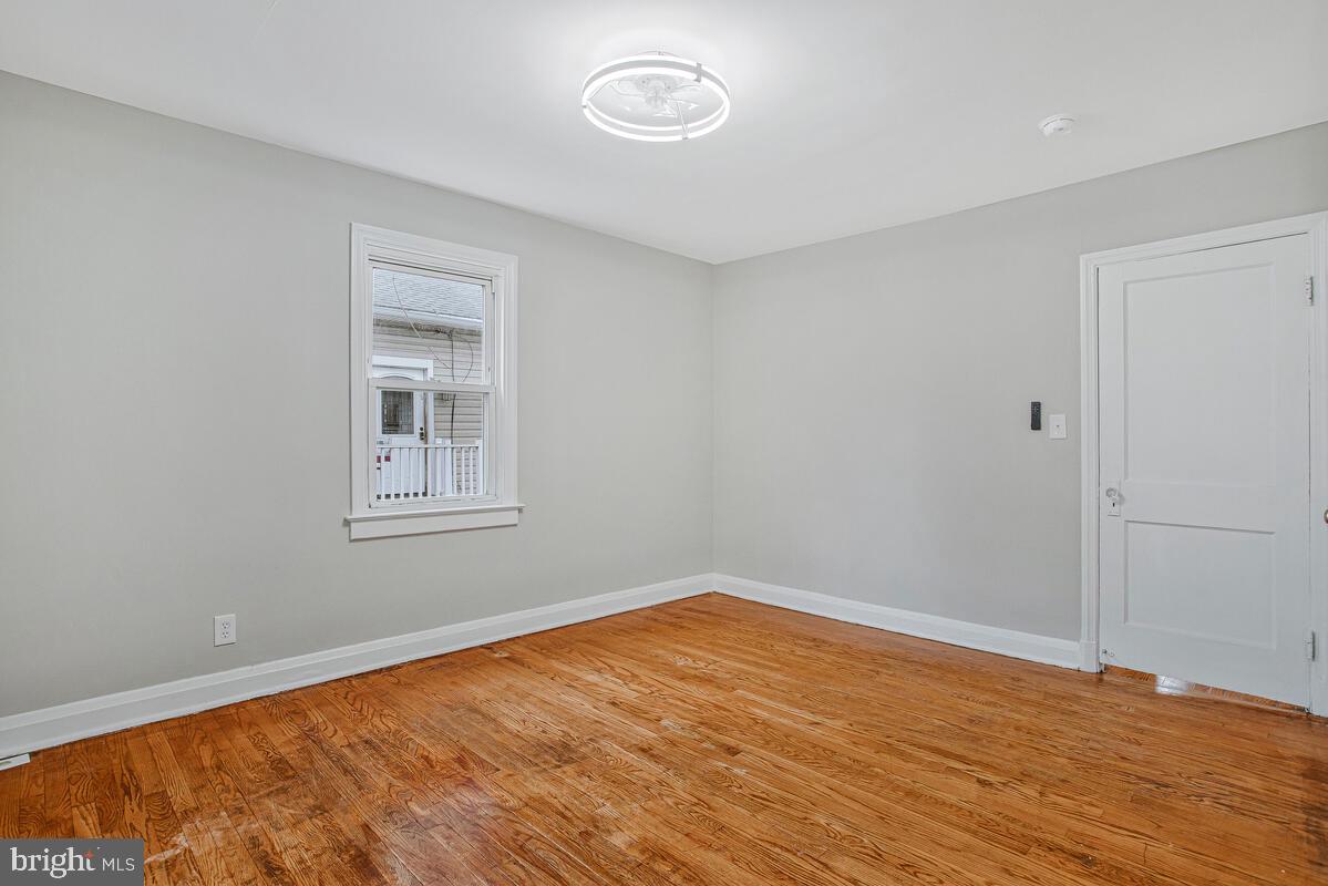 119 West Edgevale Road Baltimore, MD 21225 - Photo 16 of 37 a view of empty room with wooden floor