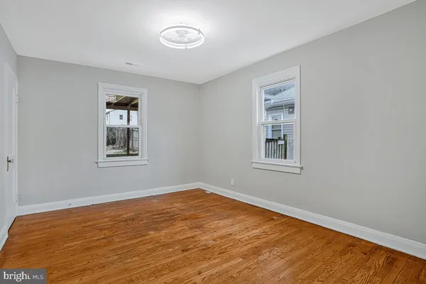 a view of a room with a wooden floor and a window