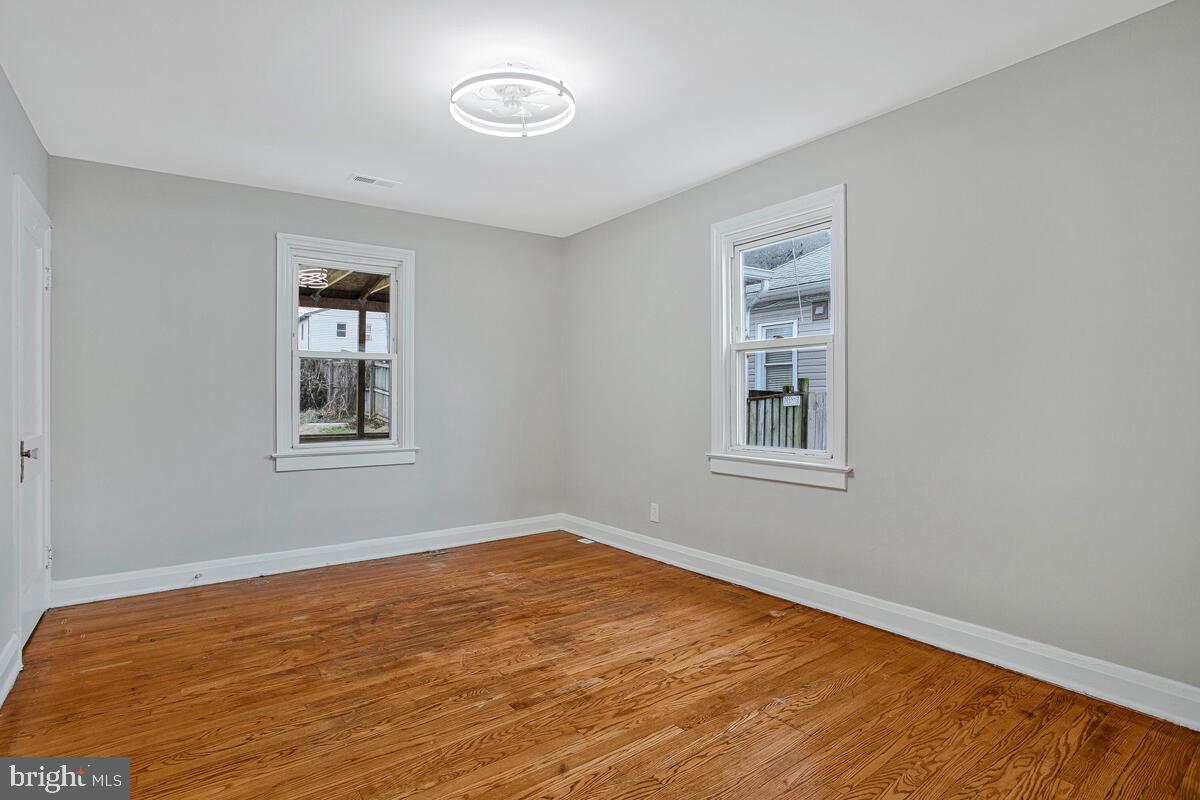 119 West Edgevale Road Baltimore, MD 21225 - Photo 19 of 37 a view of a room with a wooden floor and a window