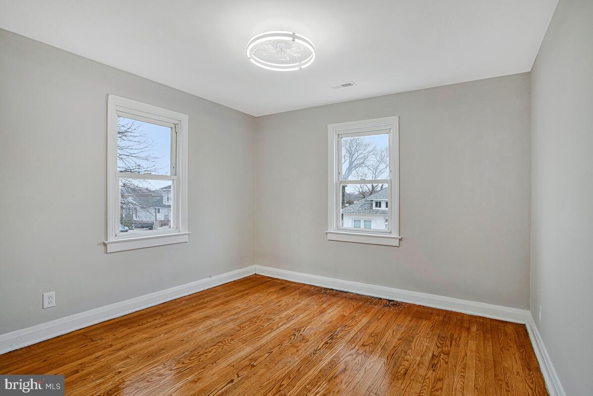 119 West Edgevale Road Baltimore, MD 21225 - Photo 21 of 37 a view of an empty room with wooden floor and a window