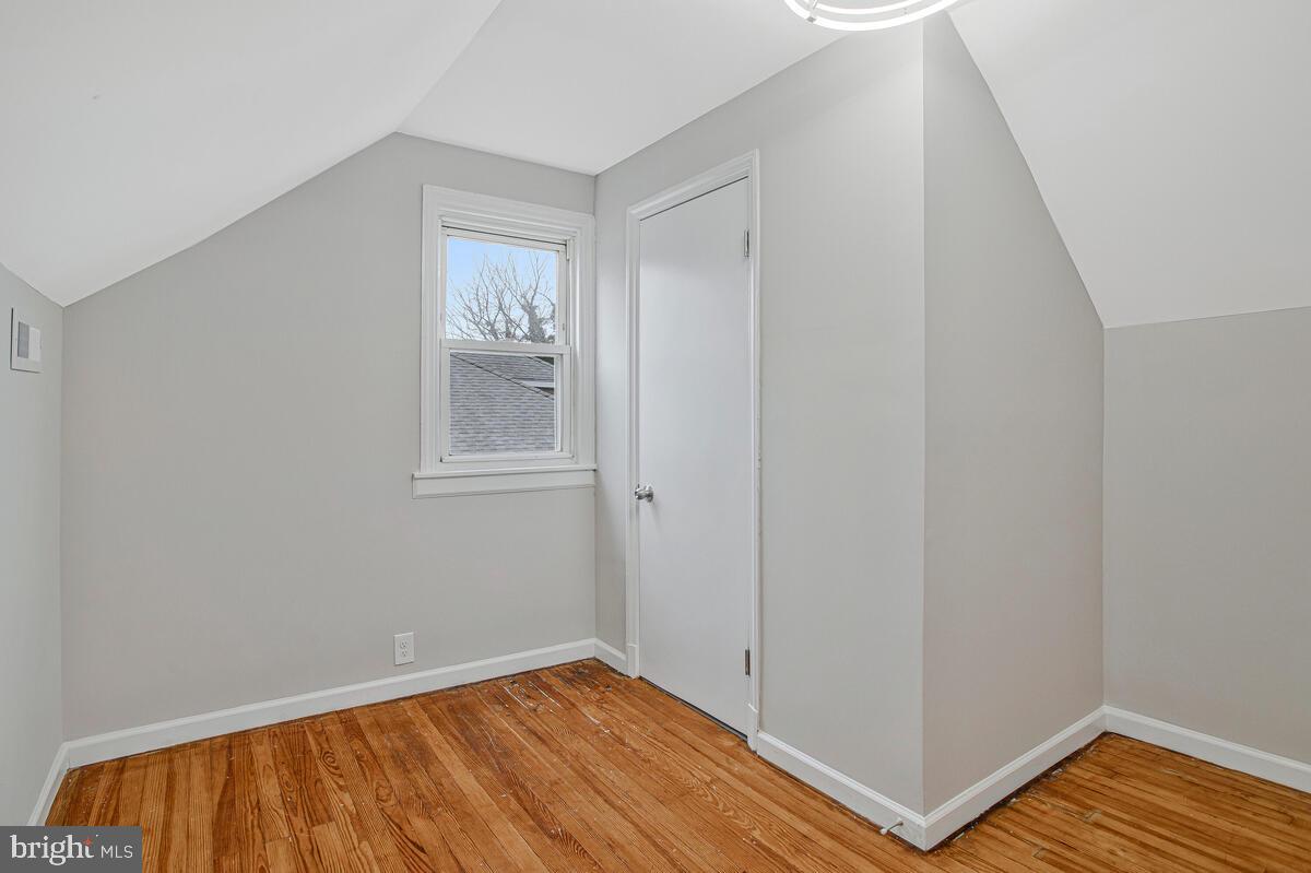 119 West Edgevale Road Baltimore, MD 21225 - Photo 24 of 37 a view of an empty room with wooden floor and a window