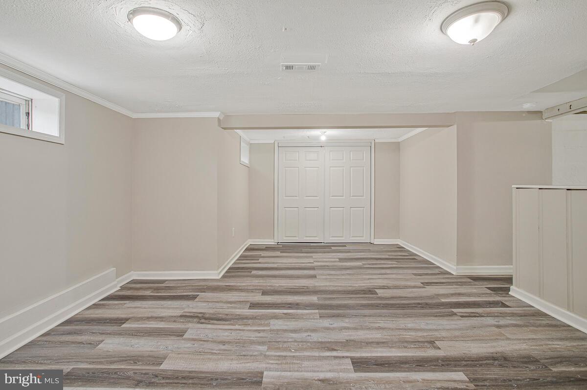 119 West Edgevale Road Baltimore, MD 21225 - Photo 27 of 37 a view of empty room with wooden floor