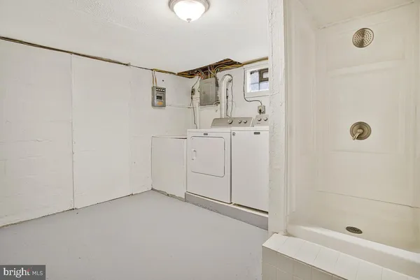 a bathroom with a shower and a sink