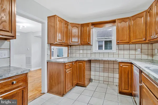 a kitchen with granite countertop a sink and cabinets