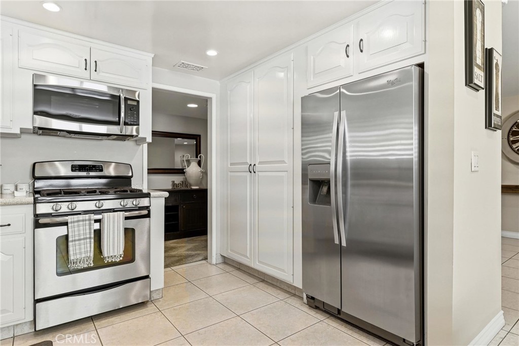 930 La Rue Avenue, Unit RUE La Verne, CA 91750 - Photo 17 of 63 a kitchen with stainless steel appliances granite countertop a refrigerator and a stove top oven