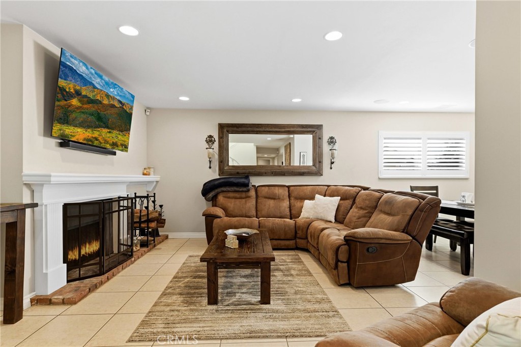 930 La Rue Avenue, Unit RUE La Verne, CA 91750 - Photo 20 of 63 a living room with furniture a flat screen tv and a fireplace