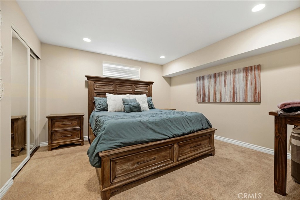 930 La Rue Avenue, Unit RUE La Verne, CA 91750 - Photo 29 of 63 a bed sitting in a room next to a lamp with a kitchen