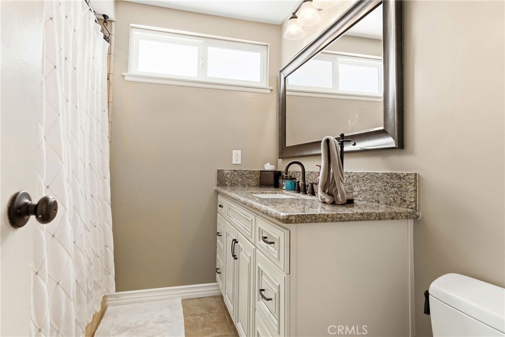 930 La Rue Avenue, Unit RUE La Verne, CA 91750 - Photo 39 of 63 a bathroom with a granite countertop sink and a mirror