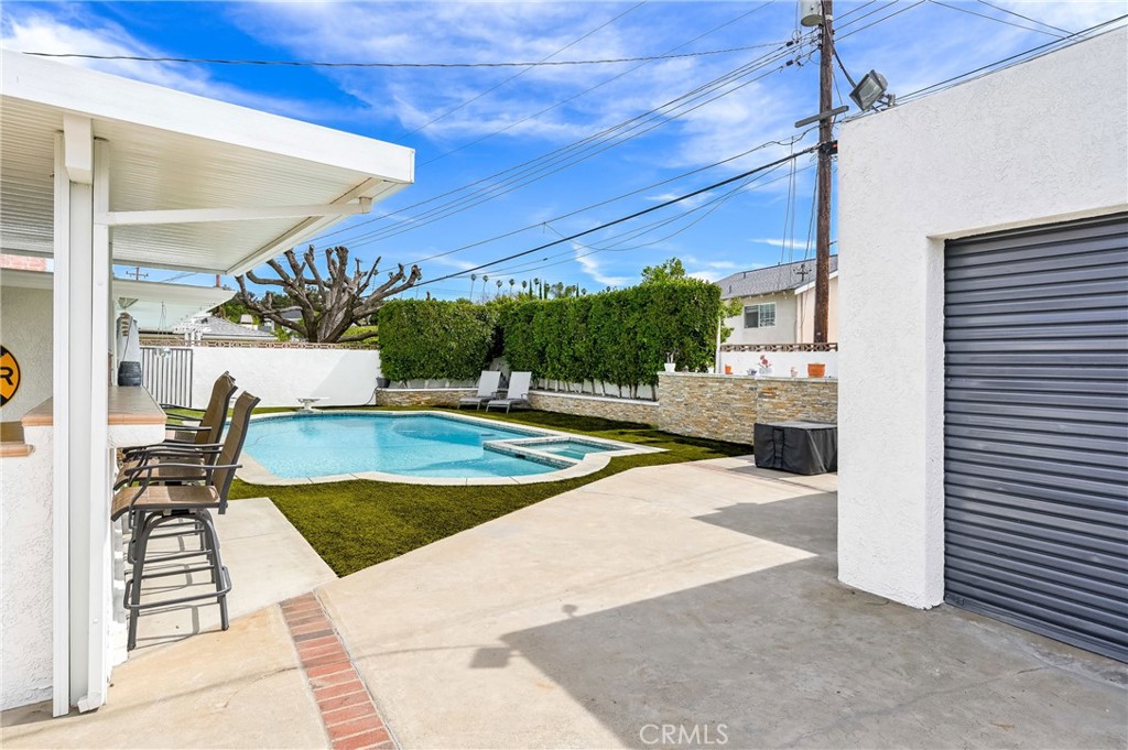 930 La Rue Avenue, Unit RUE La Verne, CA 91750 - Photo 46 of 63 a view of a patio with a table and chairs under an umbrella