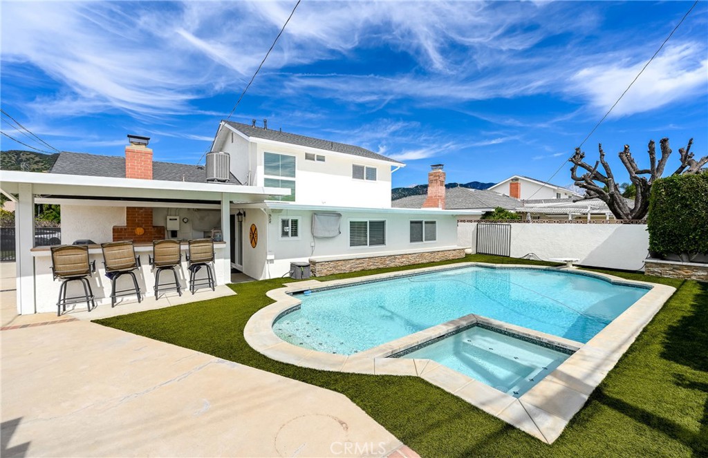 930 La Rue Avenue, Unit RUE La Verne, CA 91750 - Photo 48 of 63 a view of a house with pool and chairs