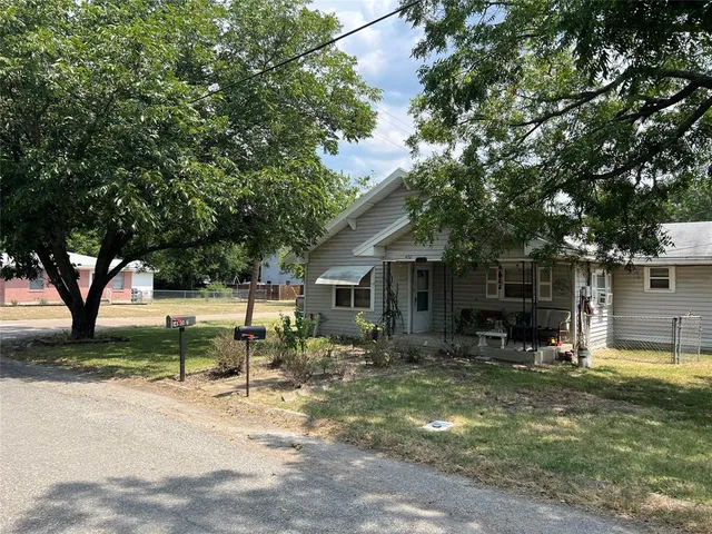 a backyard of a house with yard and outdoor seating