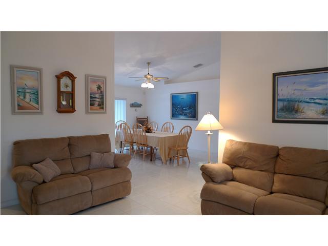 5459 Southeast Horseshoe Point Road Stuart, FL 34997 - Photo 3 of 14 a living room with furniture and a chandelier