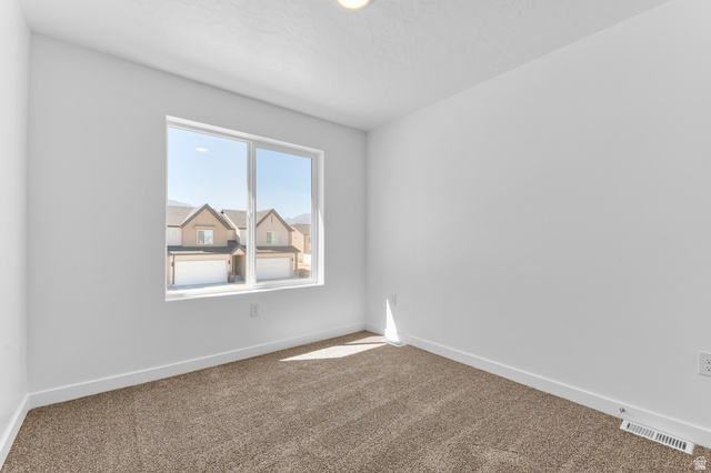 1851 East Corriente Drive, Unit 1166 Salem, UT 84653 - Photo 9 of 16 Carpeted spare room with baseboards