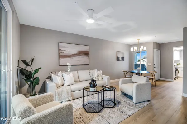 a living room with furniture and wooden floor