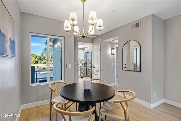 a view of a dining room with furniture wooden floor and chandelier
