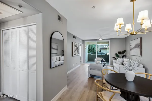 a living room with furniture and a wooden floor