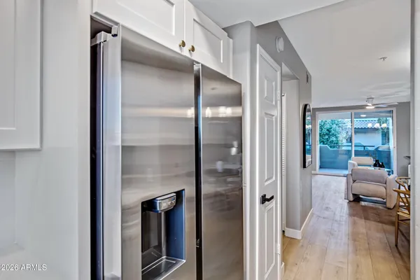 a walk in closet with wooden floor and windows