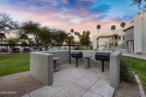 a view of a patio with a table and chairs