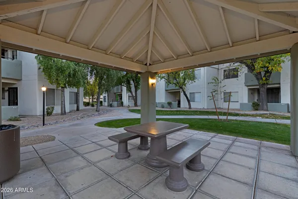 a view of a patio with a table chairs and a backyard