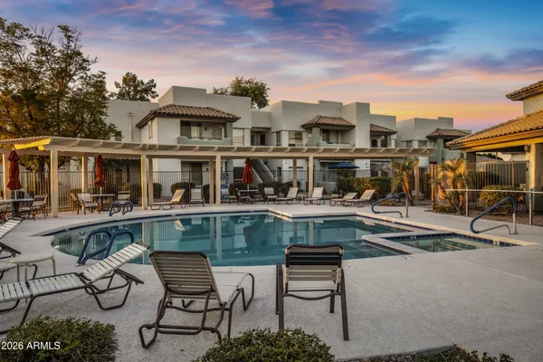 a view of a swimming pool with outdoor seating