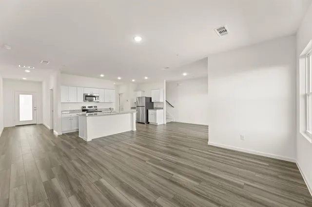 a view of kitchen with kitchen island and stainless steel appliances