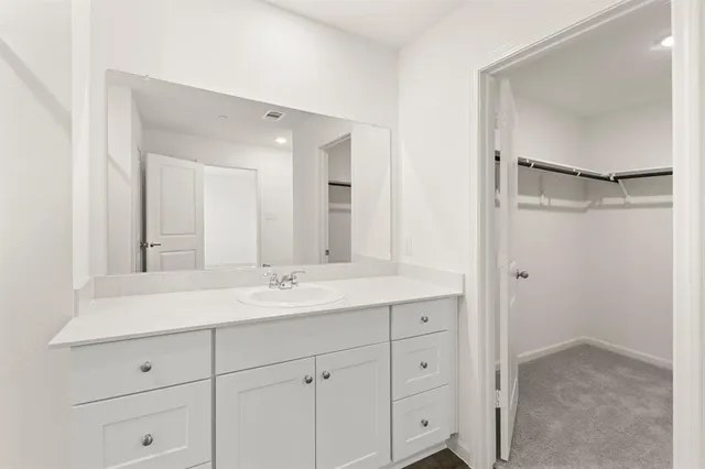 a bathroom with a double vanity sink and mirror
